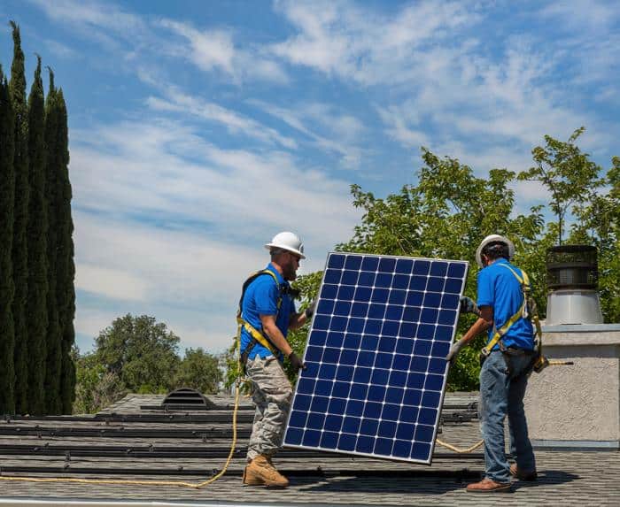 What the Current State of ITC Means for Homeowners. Two Sunergy installers are carrying a solar panel.