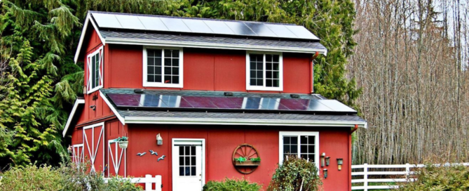 Two-story red house with Sunergy Systems solar installed.