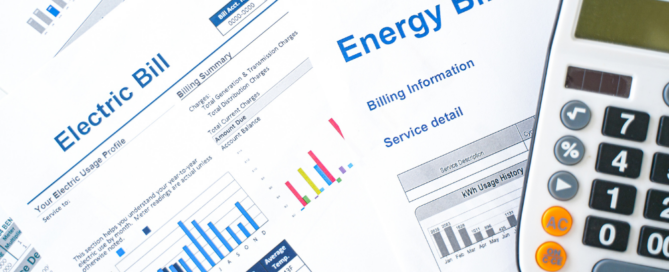 Electric and energy bills with a calculator, highlighting ways to reduce utility costs after going solar with Sunergy Systems.