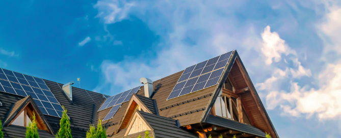 Home with rooftop solar panels under a cloudy sky, showing why solar power works in Washington's overcast weather.
