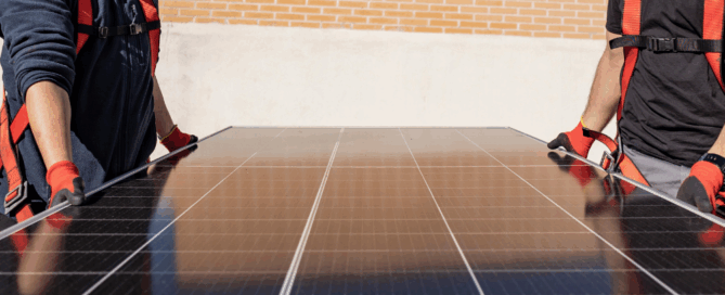 Sunergy Systems installers carrying solar panel for Washington home installation, providing clean energy solutions for homeowners